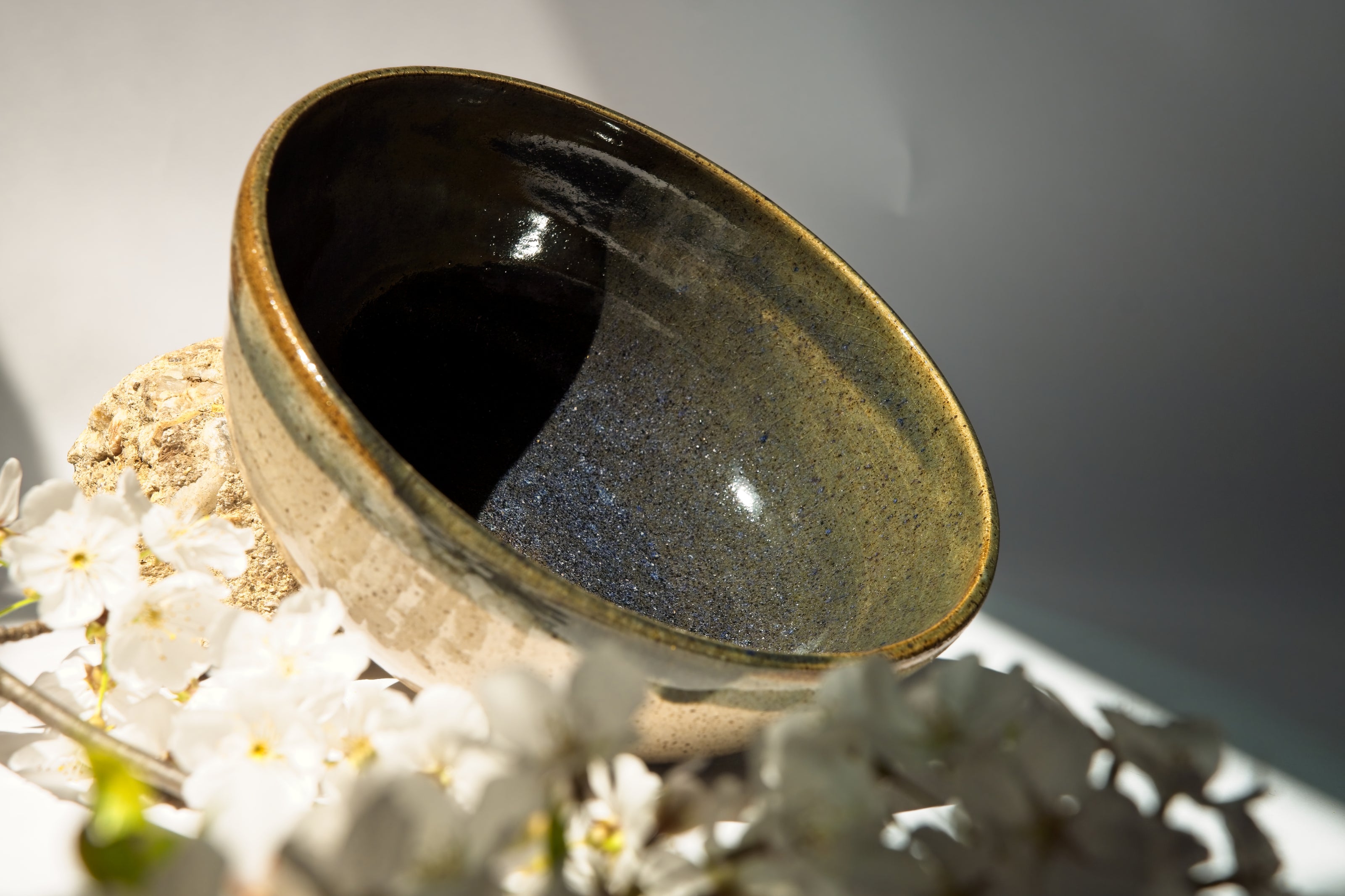 Ceramic bowl with textured dark blue surface on a white background